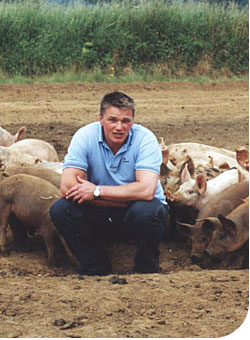 Hugh with pigs